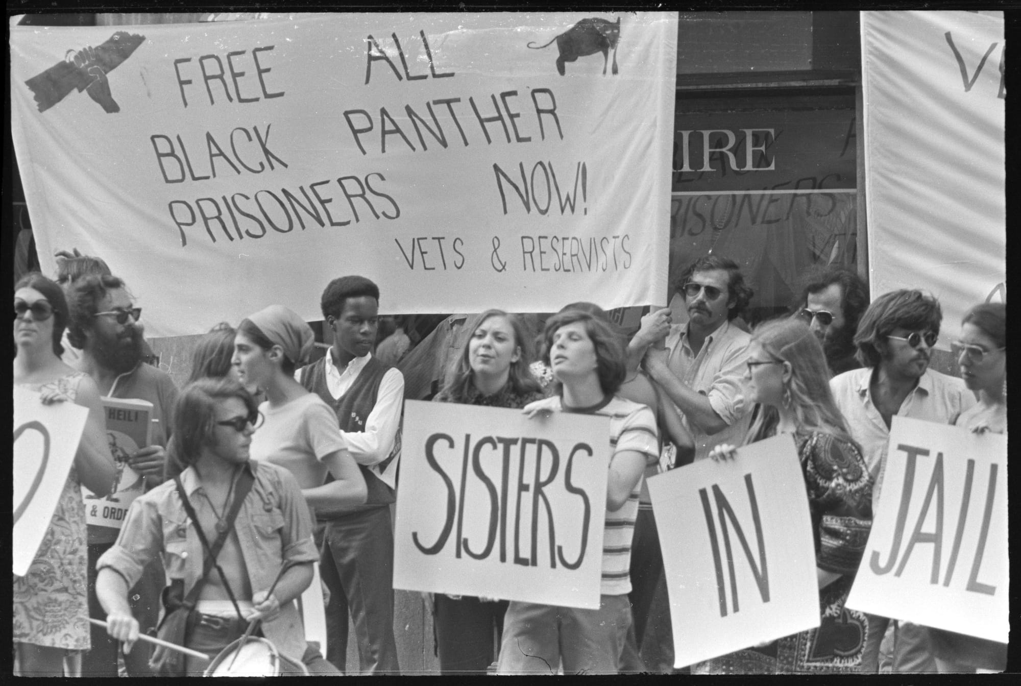 An archival shot of protesters outside the Women's House of Detention, calling to free the Black Panther prisoners