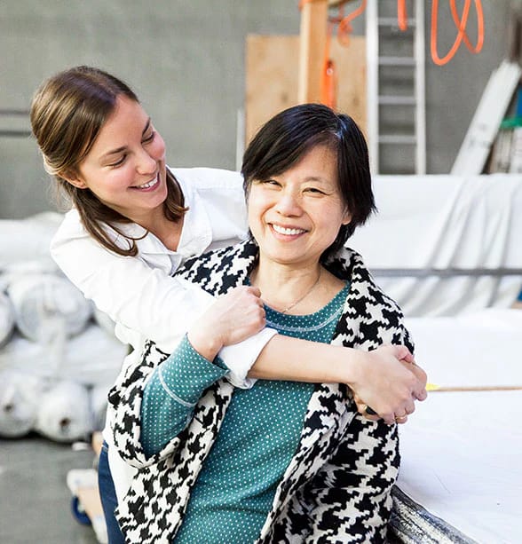 A white woman hugging an Asian woman in a corporate propaganda photo I stole from Marine Layer's website