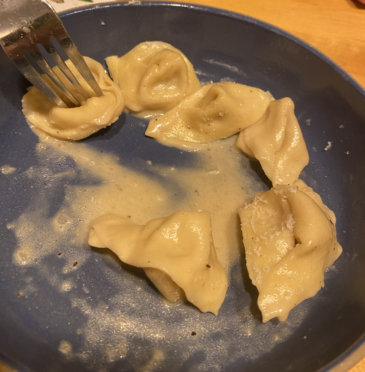 Agnolotti and sauce in a bowl, nearly completely eaten because I forgot to take a picture