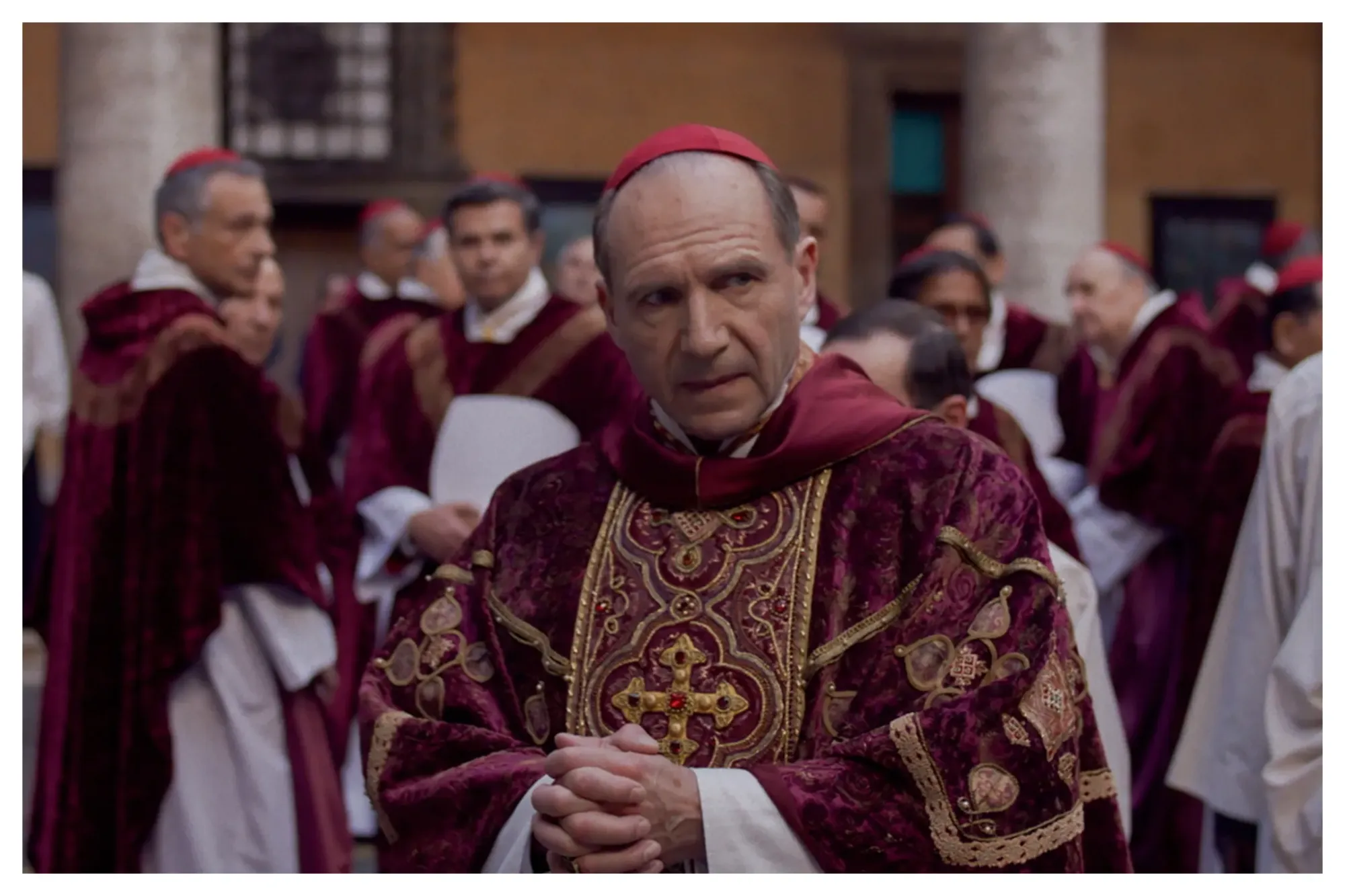 Ralph Fiennes serving face, outfit, and drama in a still from Conclave