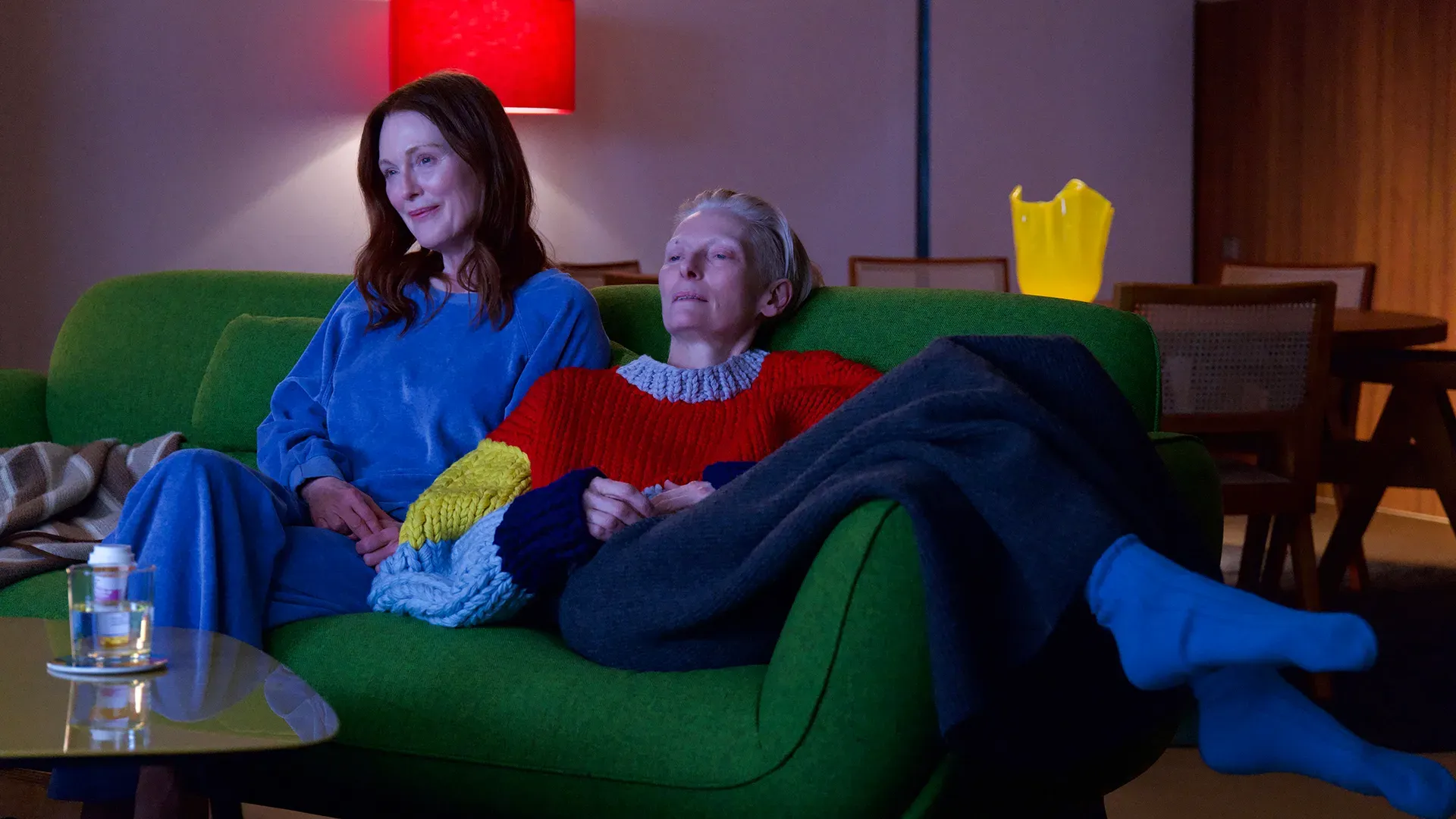 Tilda Swinton and Julianne Moore looking cozy and like the iconic mothers they are together in a still from The Room Next Door