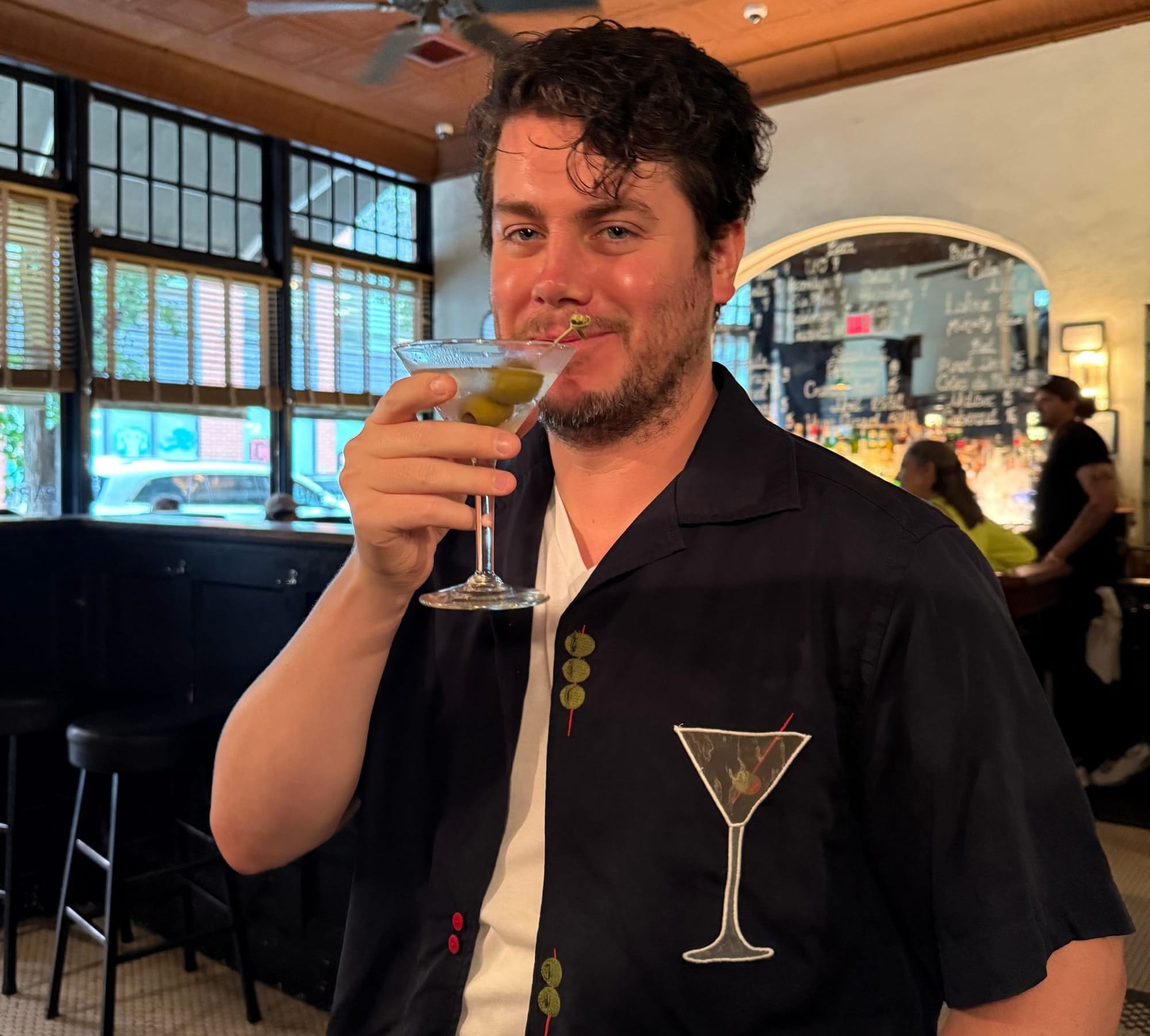 A photo of me, Danny, wearing my stupid new shirt with a martini-shaped pocket and olive-shaped buttons, looking very wet and rosy-cheeked for some reason even though you can clearly see the martini in my hand is still nearly completely full, so I can't have had that much to drink?